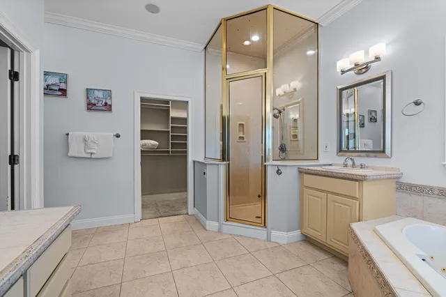 a bathroom with a sink and mirror with shower