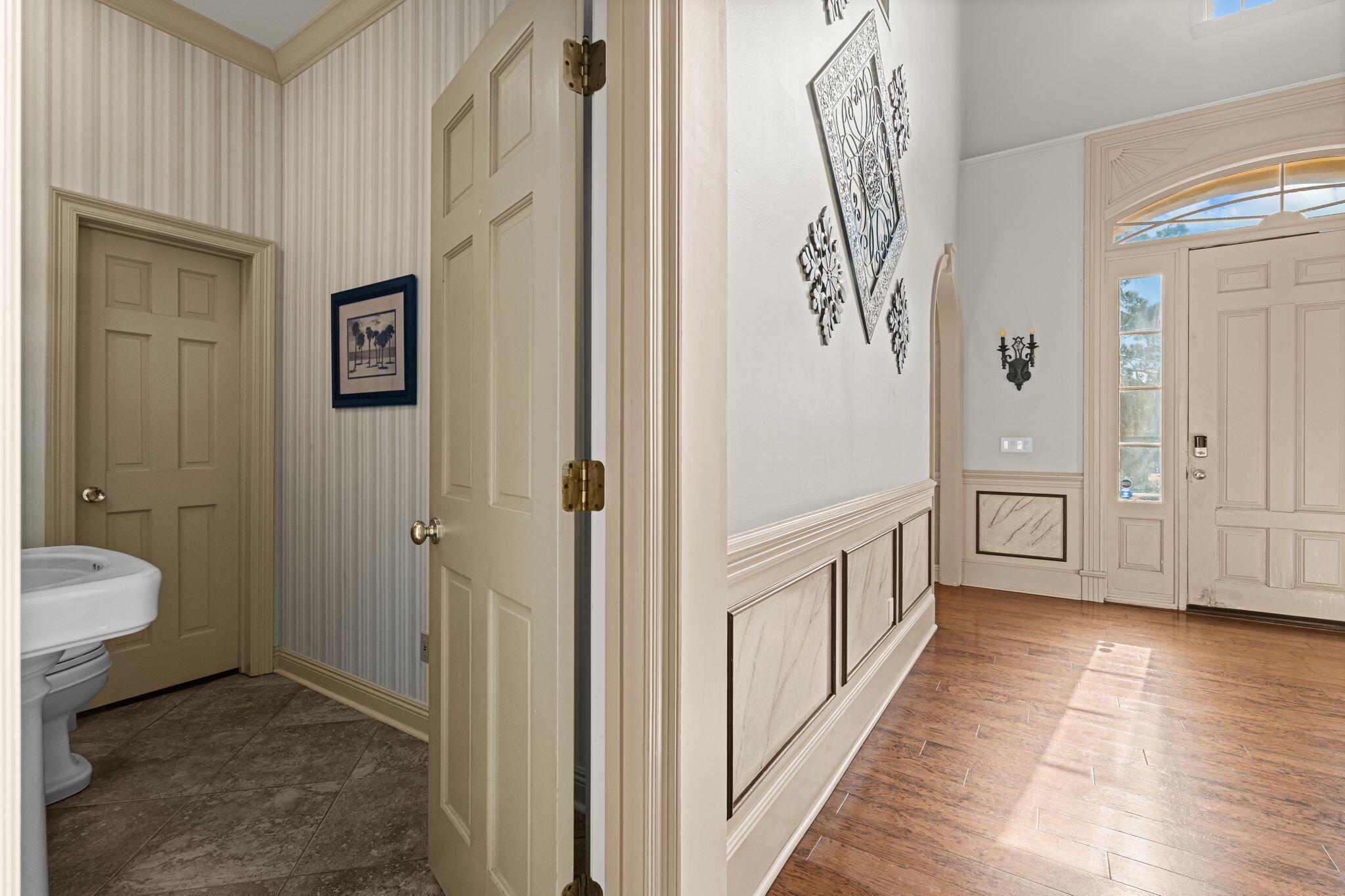 322 Wahoo Road Panama City Beach, FL 32408 - Photo 38 of 57 a view of a hallway with bathroom and wooden floor