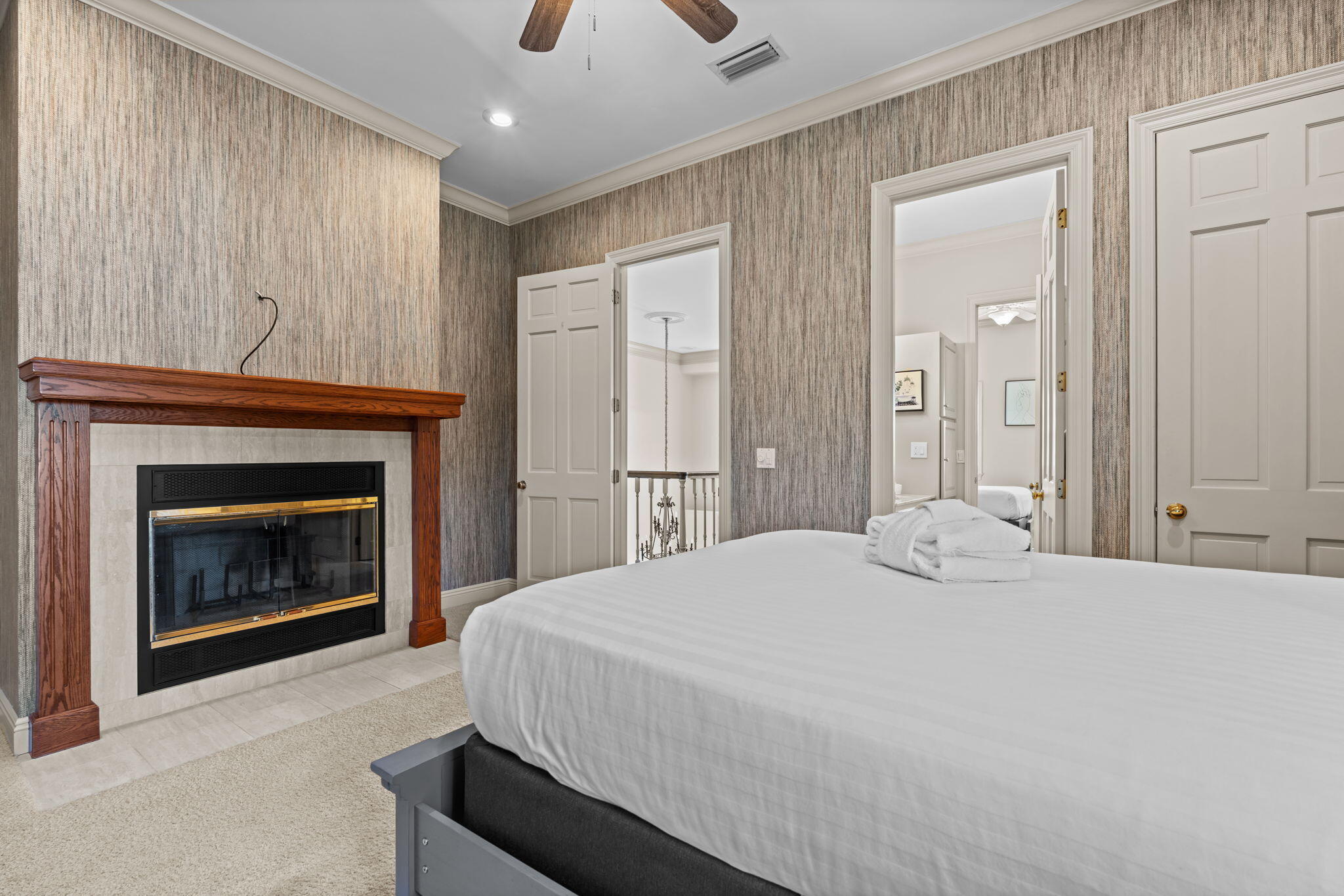 322 Wahoo Road Panama City Beach, FL 32408 - Photo 48 of 57 a bedroom with a bed and a fireplace