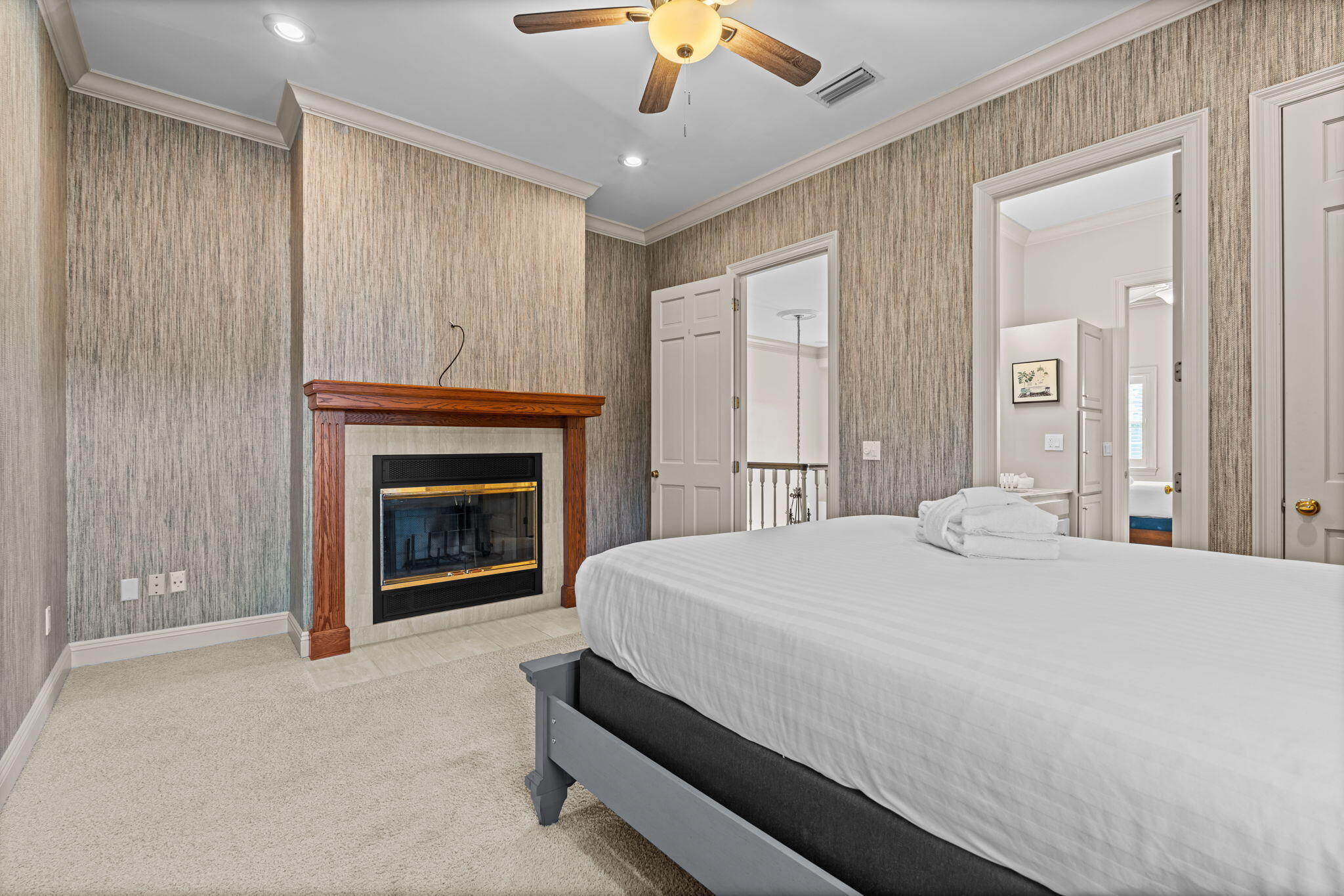 322 Wahoo Road Panama City Beach, FL 32408 - Photo 49 of 57 a spacious bedroom with a bed and a fireplace