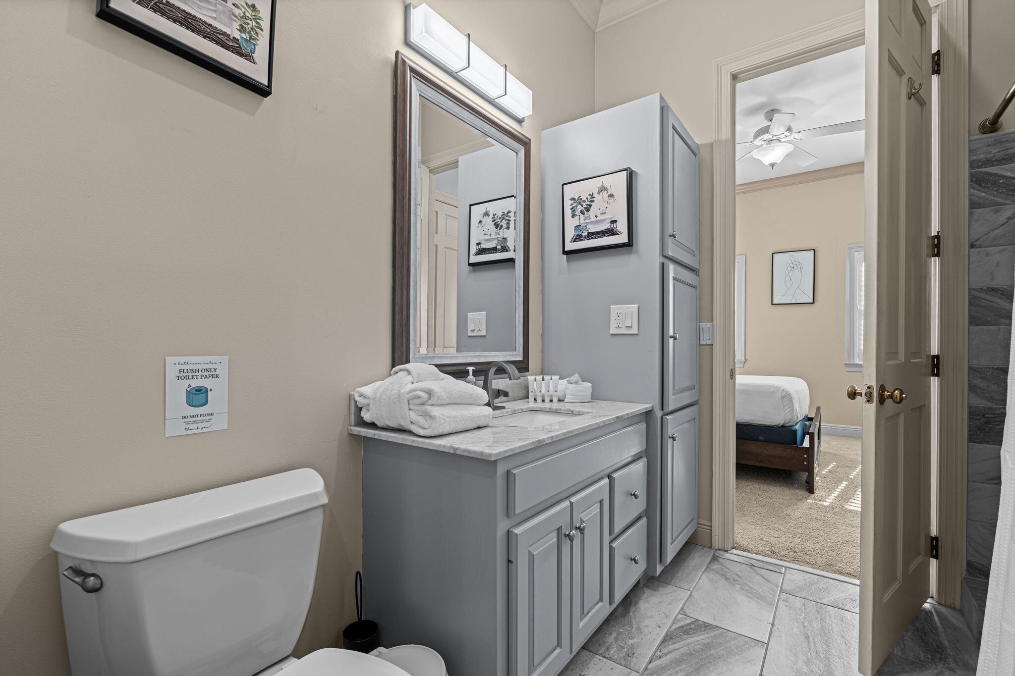 322 Wahoo Road Panama City Beach, FL 32408 - Photo 50 of 57 a bathroom with a toilet sink and mirror