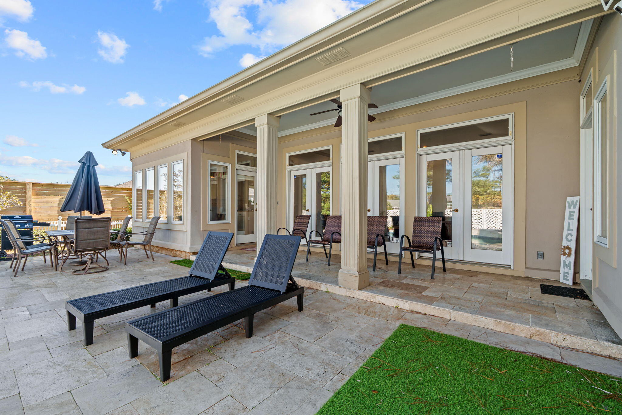 322 Wahoo Road Panama City Beach, FL 32408 - Photo 5 of 57 a view of a patio with table and chairs with a barbeque grill and couches