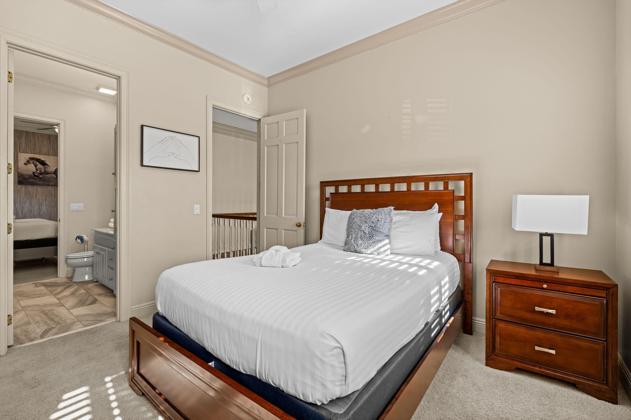 322 Wahoo Road Panama City Beach, FL 32408 - Photo 52 of 57 a bedroom with a bed and a lamp on dresser