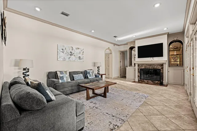 a spacious bedroom with a bed and a flat screen tv