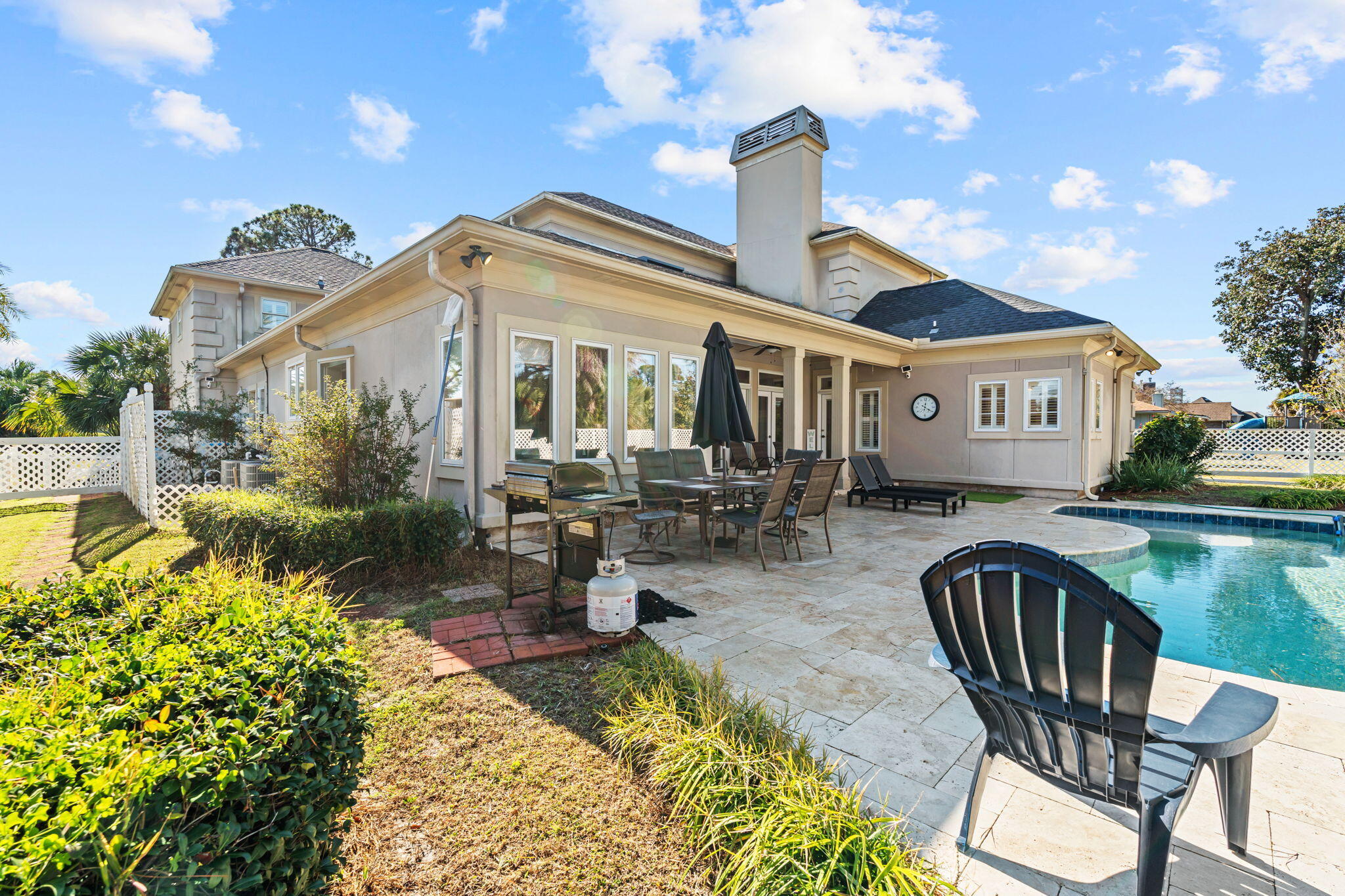 322 Wahoo Road Panama City Beach, FL 32408 - Photo 9 of 57 a front view of a house with swimming pool table and chairs