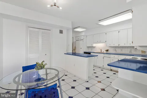 a kitchen with granite countertop a sink a stove a microwave and cabinets