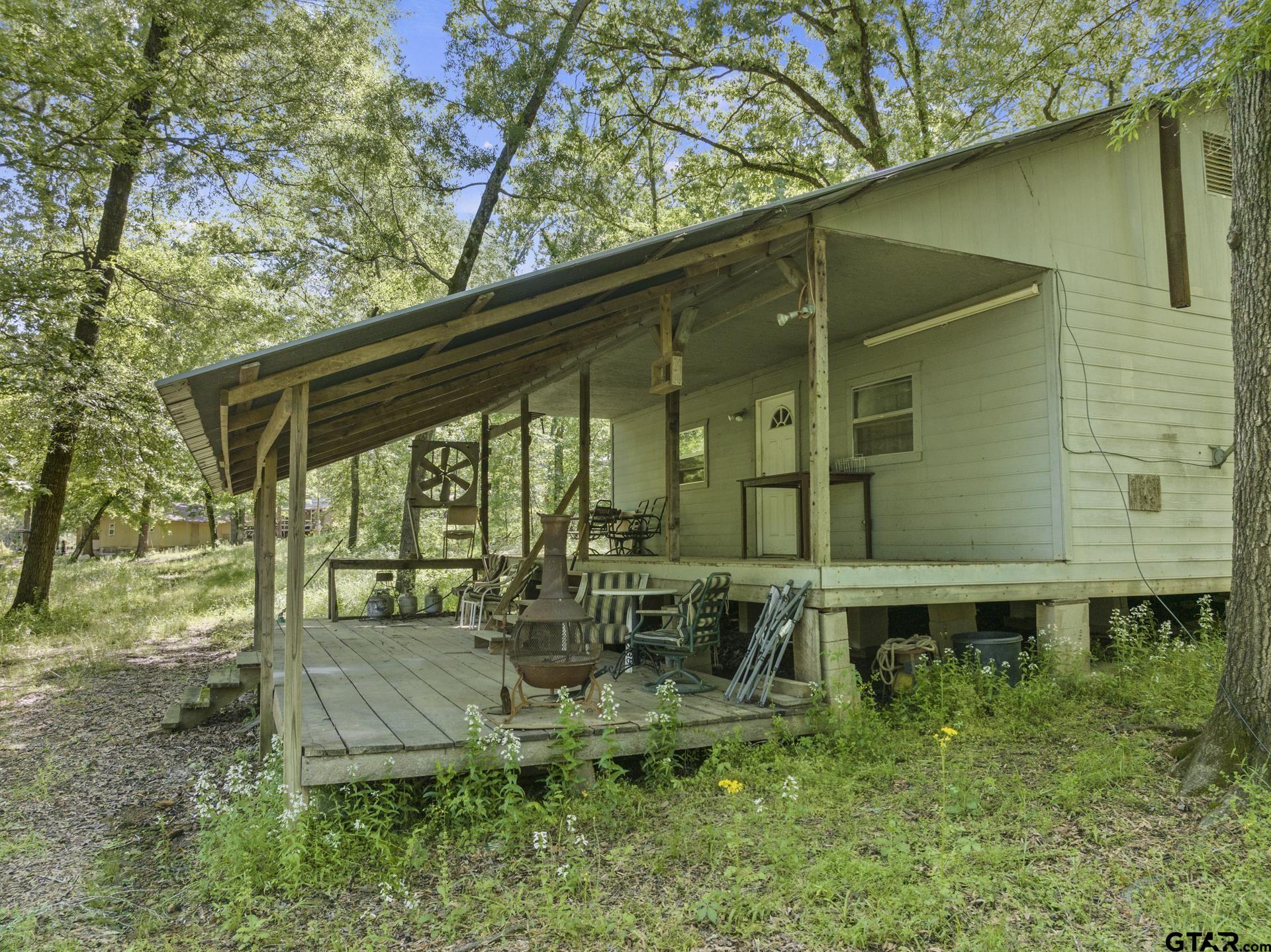 307 Fish Trap Lane Naples, TX 75568 - Photo 2 of 41 a backyard of a house with outdoor seating