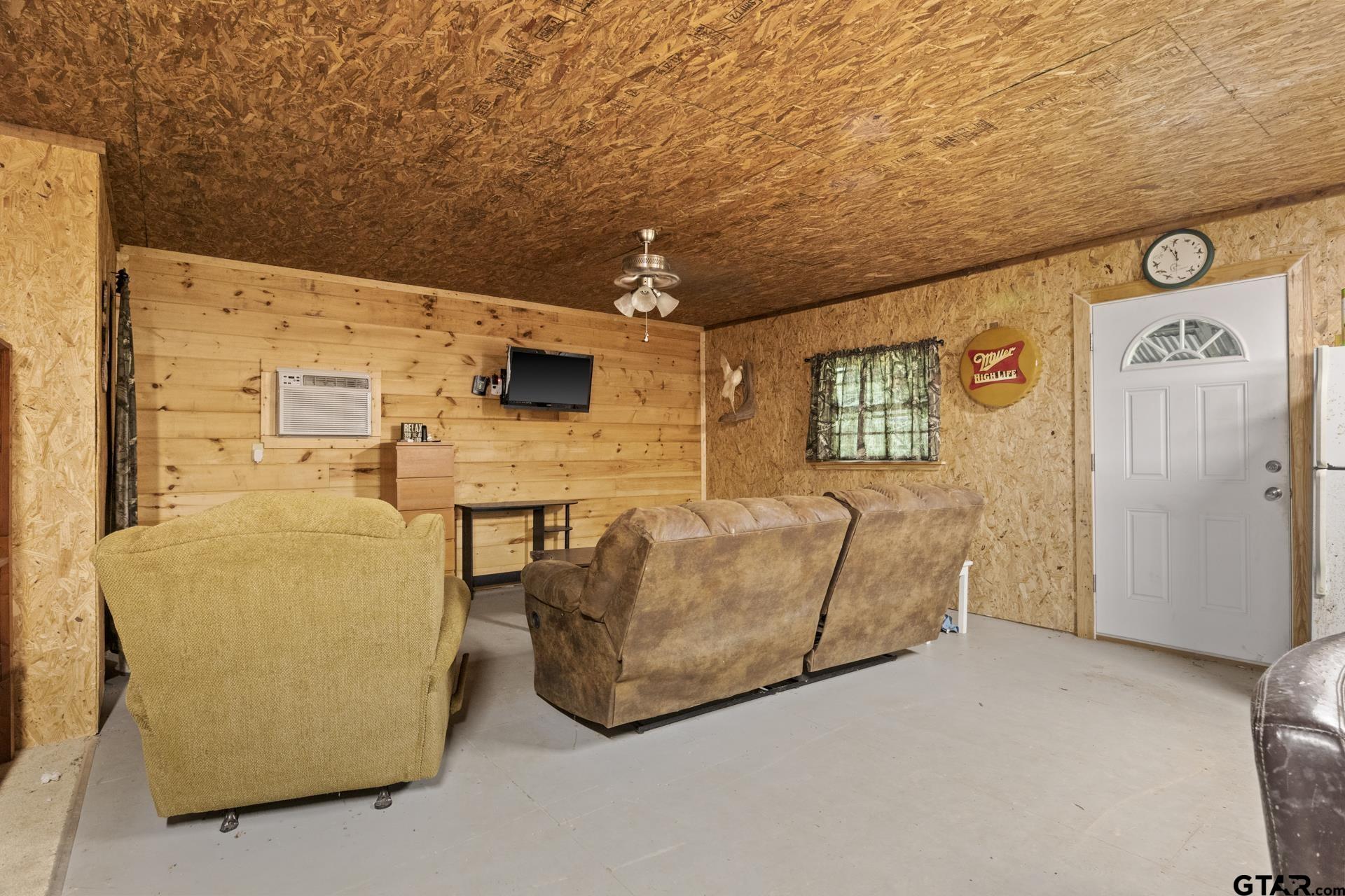 307 Fish Trap Lane Naples, TX 75568 - Photo 7 of 41 a living room with furniture and a refrigerator