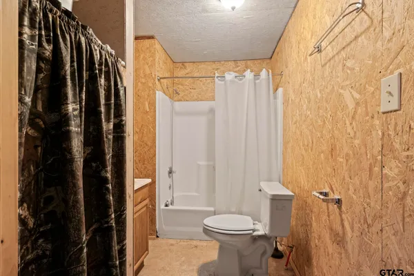 a bathroom with a shower curtain and a sink