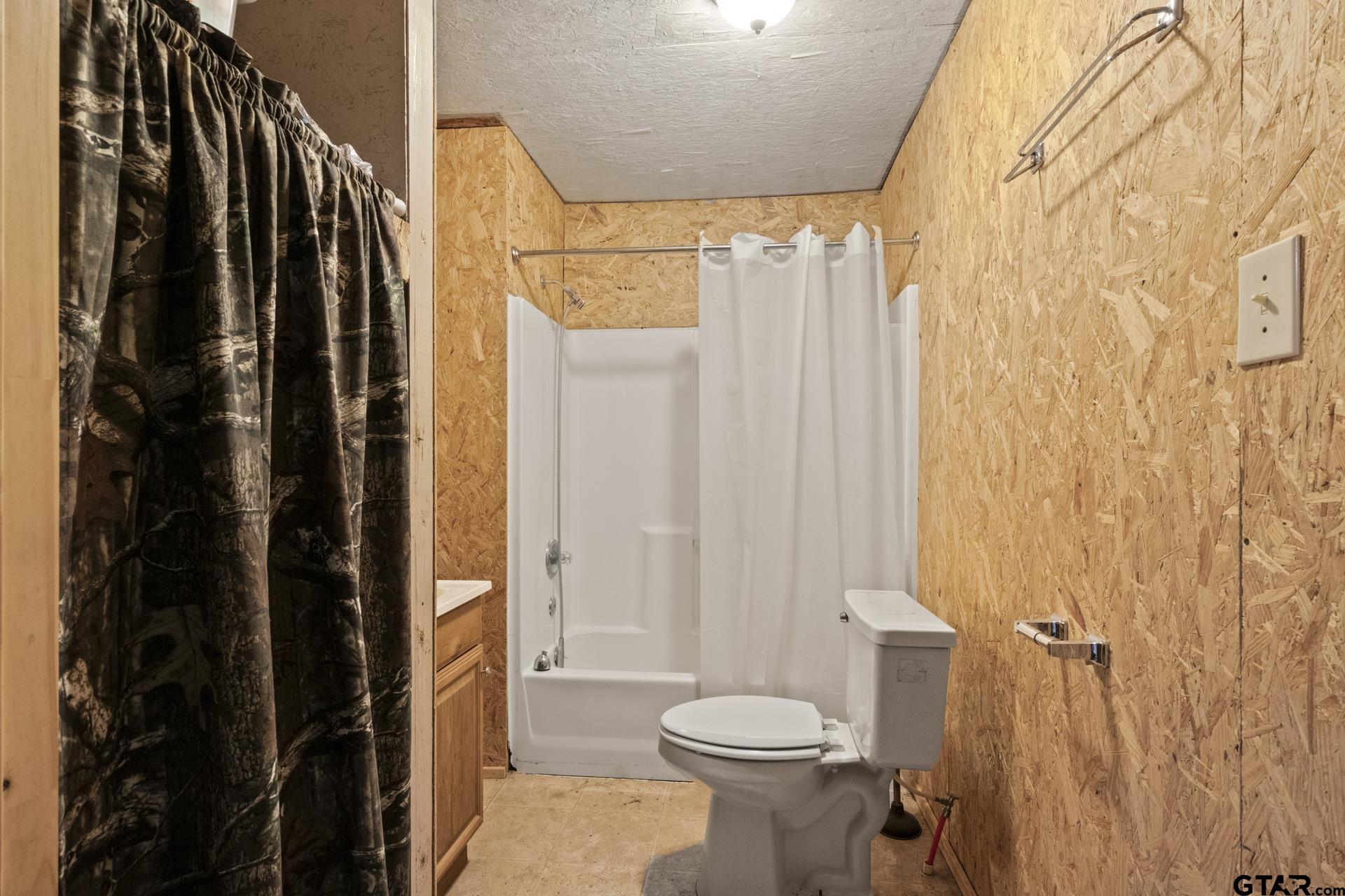 307 Fish Trap Lane Naples, TX 75568 - Photo 10 of 41 a bathroom with a shower curtain and a sink