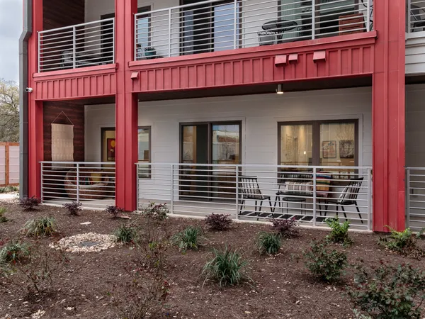 a view of a house with a yard and wooden fence