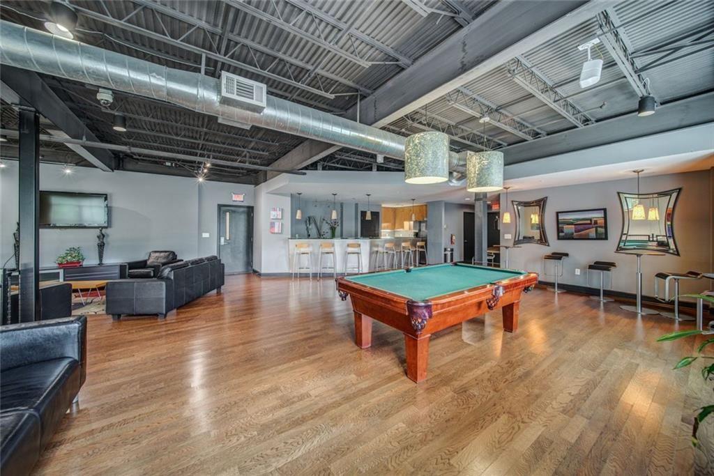 5300 Peachtree Road, Unit 2604 Atlanta, GA 30341 - Photo 6 of 39 a living room with furniture pool table and a wooden floor