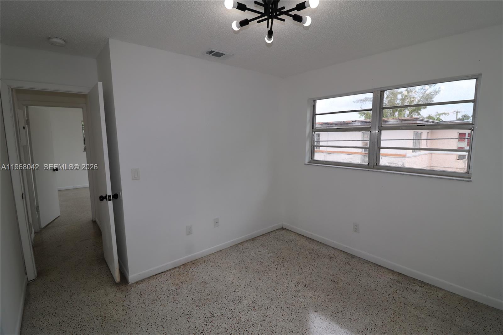 951 Southwest 7th Street, Unit 5 Miami, FL 33130 - Photo 12 of 23 an empty room with a window