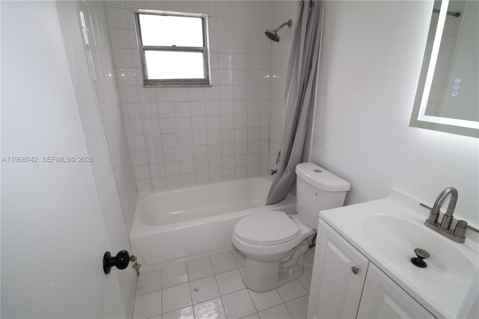 951 Southwest 7th Street, Unit 5 Miami, FL 33130 - Photo 13 of 23 a white toilet sitting next to a bath tub
