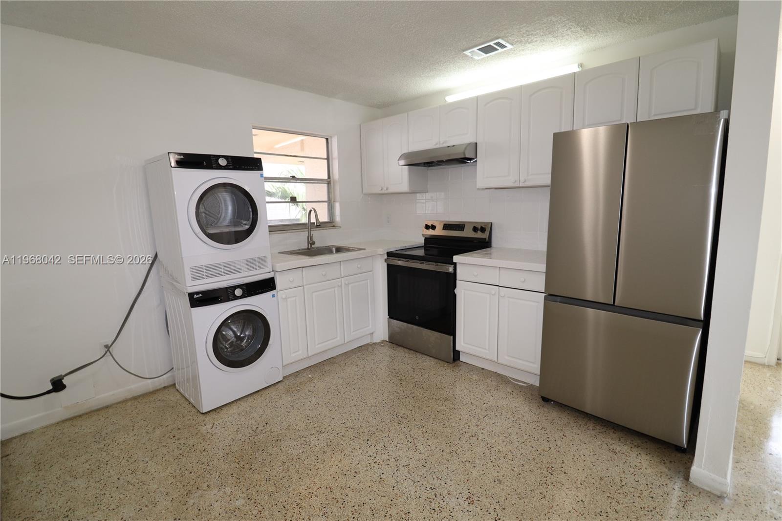 951 Southwest 7th Street, Unit 5 Miami, FL 33130 - Photo 17 of 23 a kitchen with a refrigerator and a stove top oven