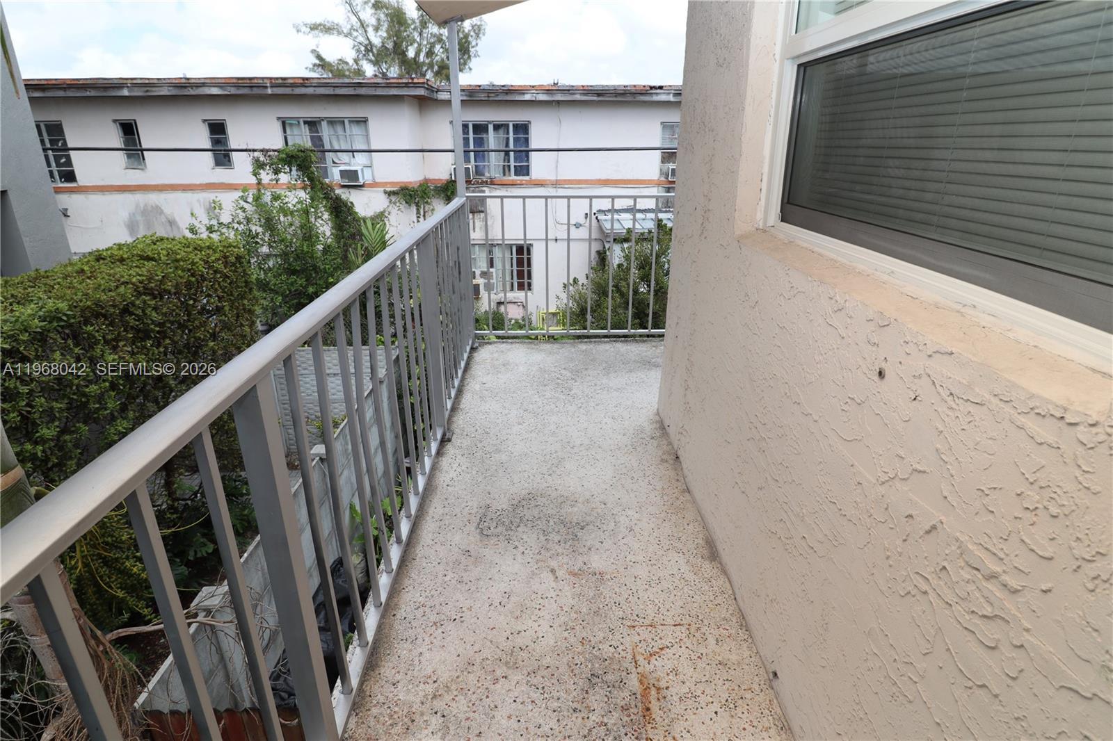 951 Southwest 7th Street, Unit 5 Miami, FL 33130 - Photo 19 of 23 a view of a house with wooden floor and floor to ceiling window