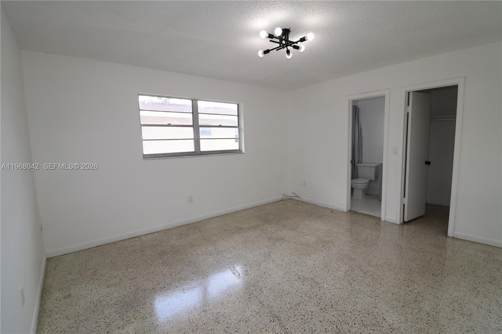 951 Southwest 7th Street, Unit 5 Miami, FL 33130 - Photo 5 of 23 a view of an empty room with a window