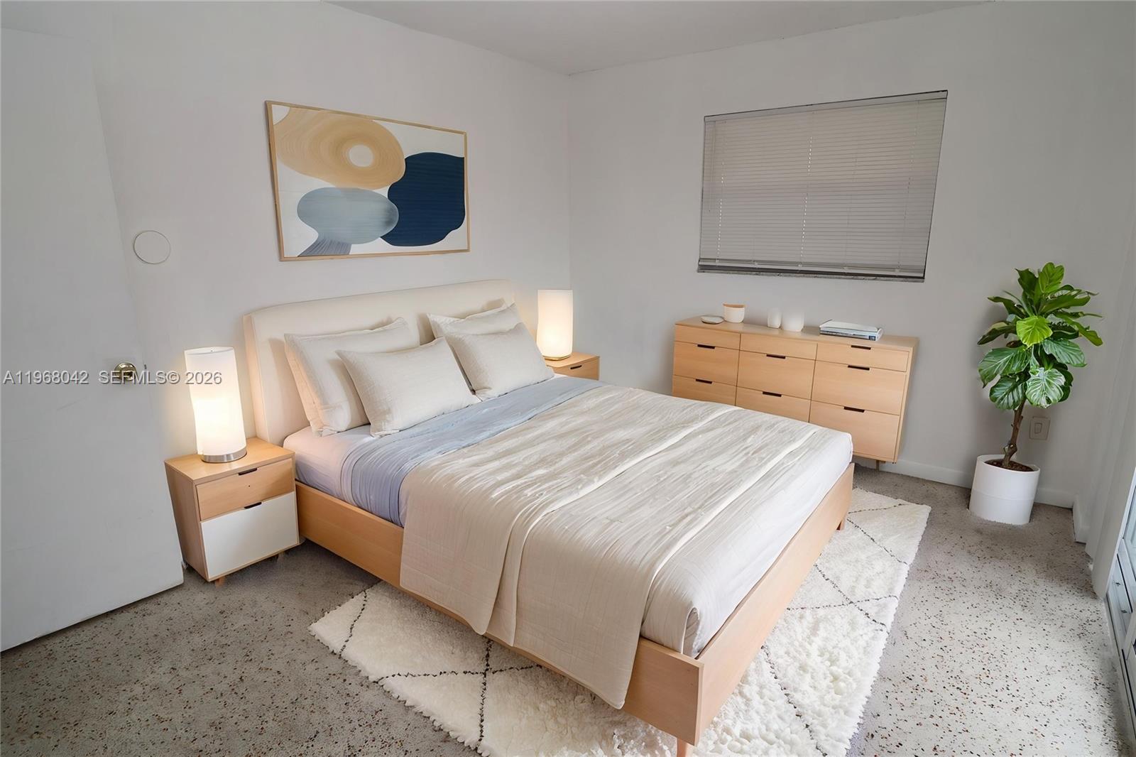 951 Southwest 7th Street, Unit 5 Miami, FL 33130 - Photo 6 of 23 a bedroom with a bed and a painting on the wall