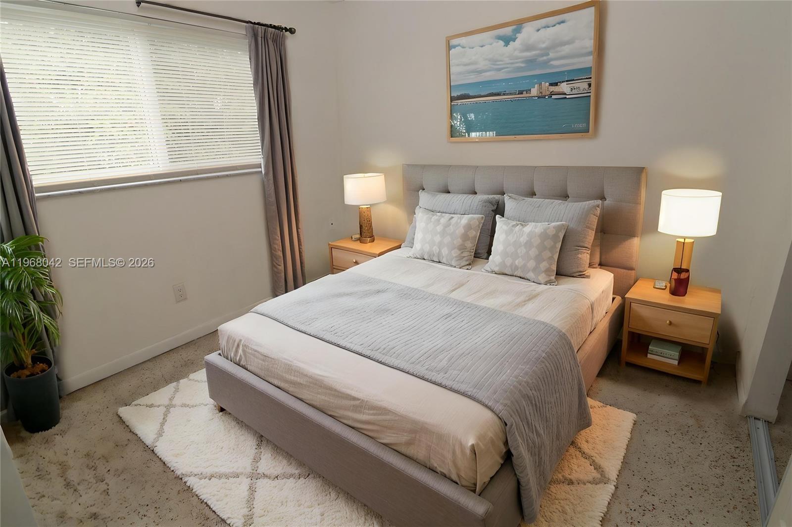 951 Southwest 7th Street, Unit 5 Miami, FL 33130 - Photo 9 of 23 a bed room with a bed and a lamp