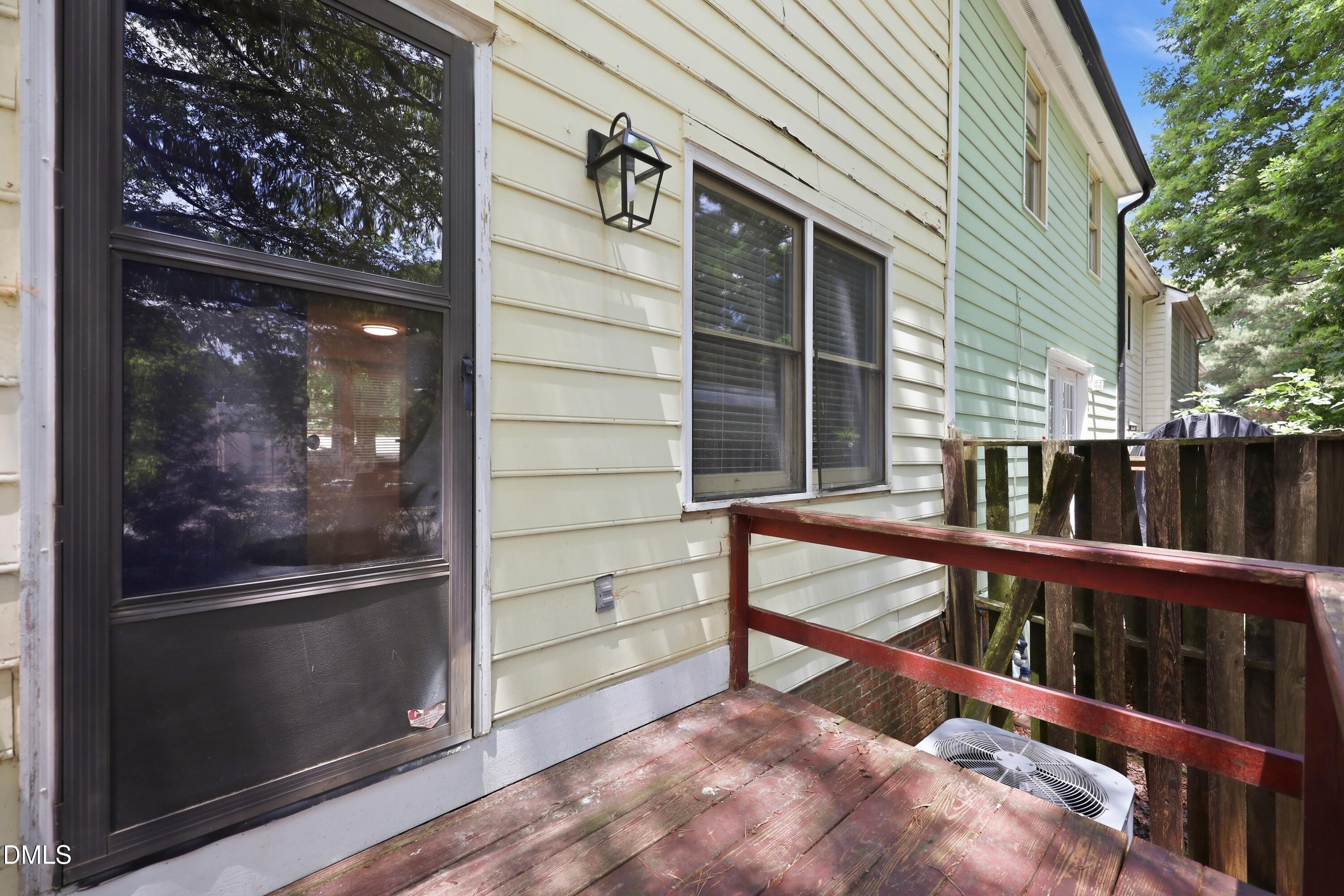 669 Bashford Road Raleigh, NC 27606 - Photo 14 of 19 a view of a porch with wooden floor and iron stairs