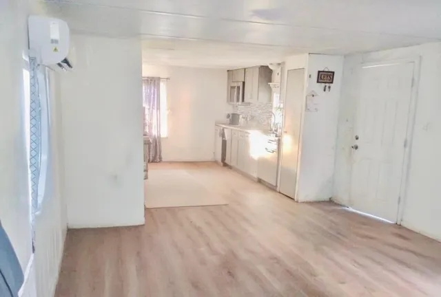 a view of a kitchen with a sink and a refrigerator