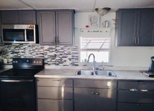 a kitchen with stainless steel appliances wooden cabinets and a sink