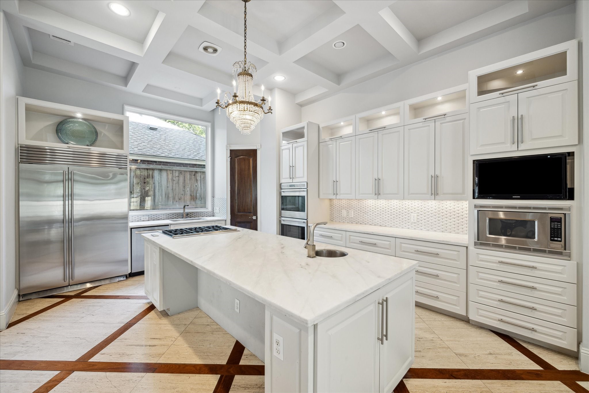2247 Bartlett Street Houston, TX 77098 - Photo 12 of 50 The gourmet KITCHEN is equipped with a marble center island housing a separate prep sink and storage cabinets, double ovens and ample counter and cabinet space.