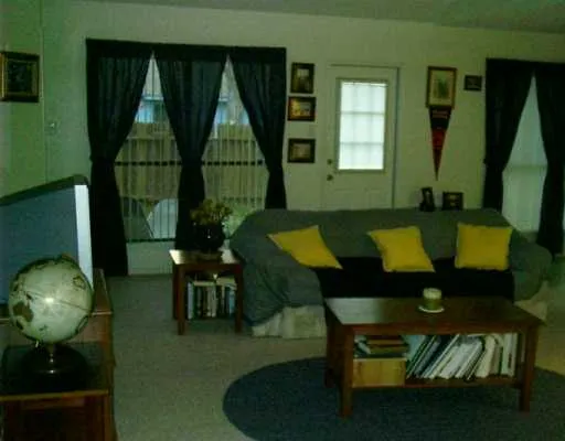 a bed sitting in a bedroom next to a lamp