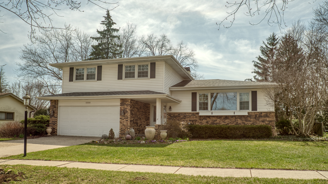 1200 Ridgeway Drive Elgin, IL 60123 - Photo 3 of 34 a front view of a house with a yard and garage