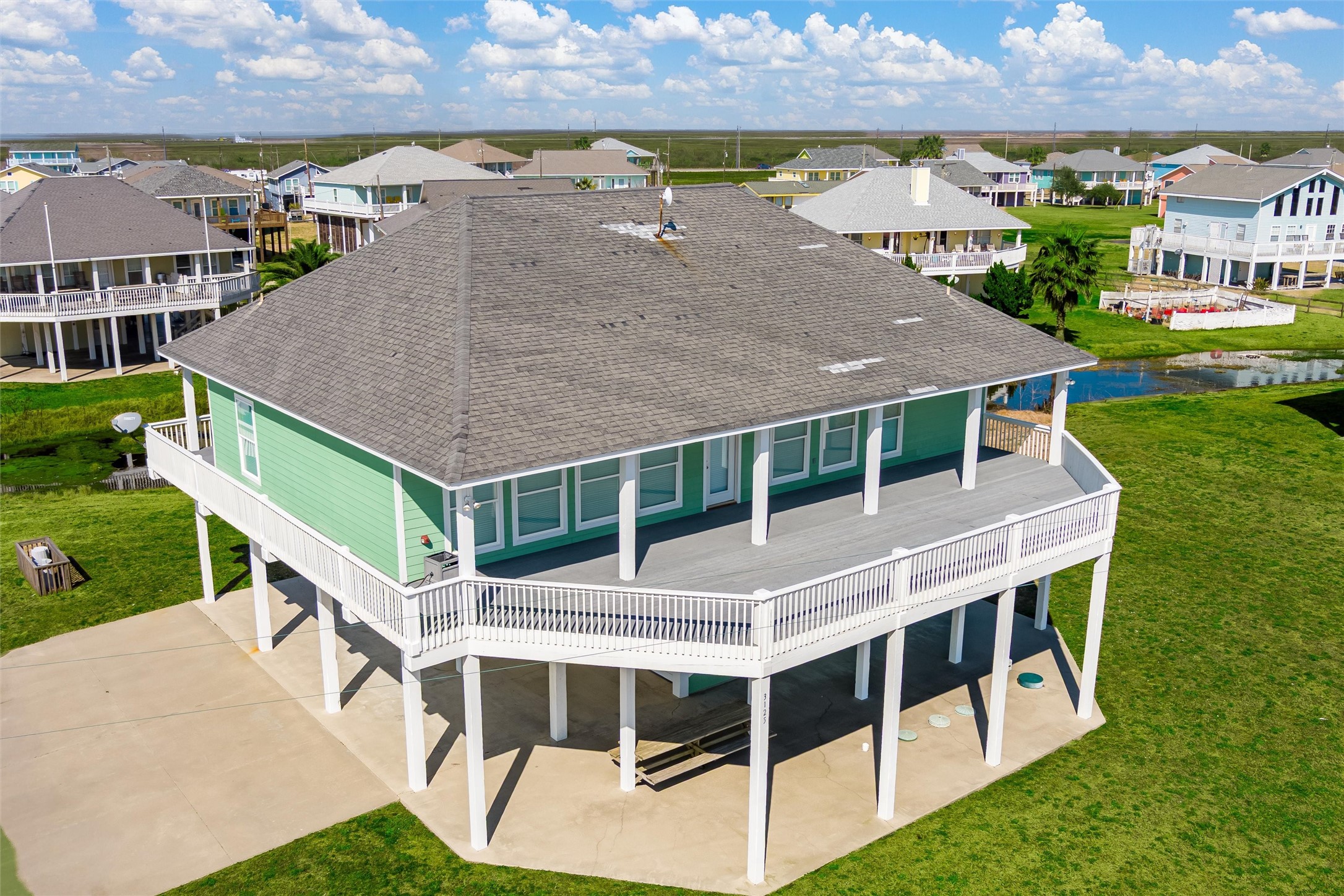 an aerial view of a house with a yard