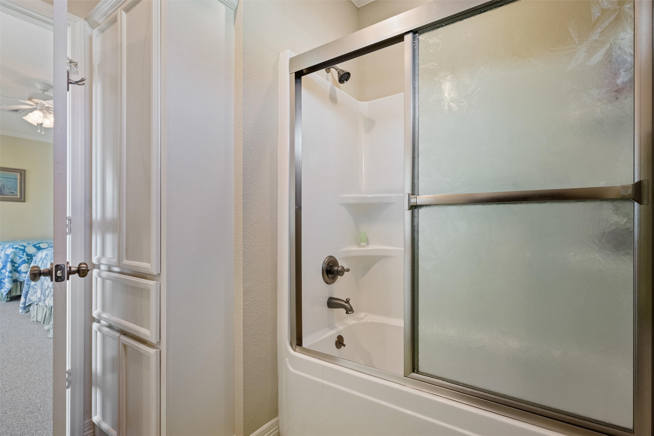 3125 James Street Crystal Beach, TX 77650 - Photo 30 of 45 a bathroom with a shower and a glass door