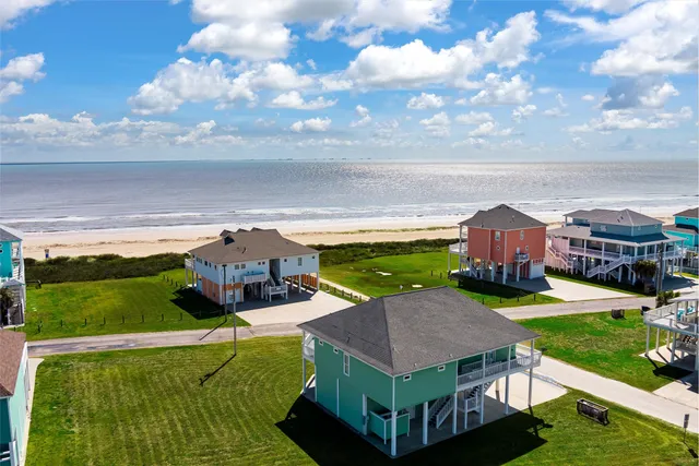 a aerial view of a house with swimming pool garden and patio