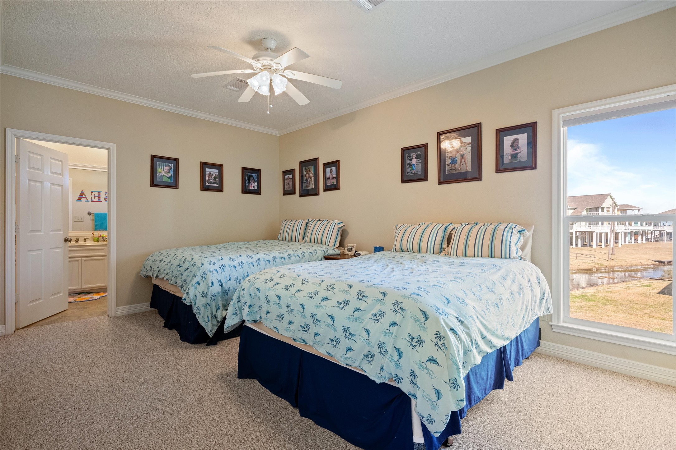 3125 James Street Crystal Beach, TX 77650 - Photo 35 of 45 a bedroom with a large bed and a chandelier