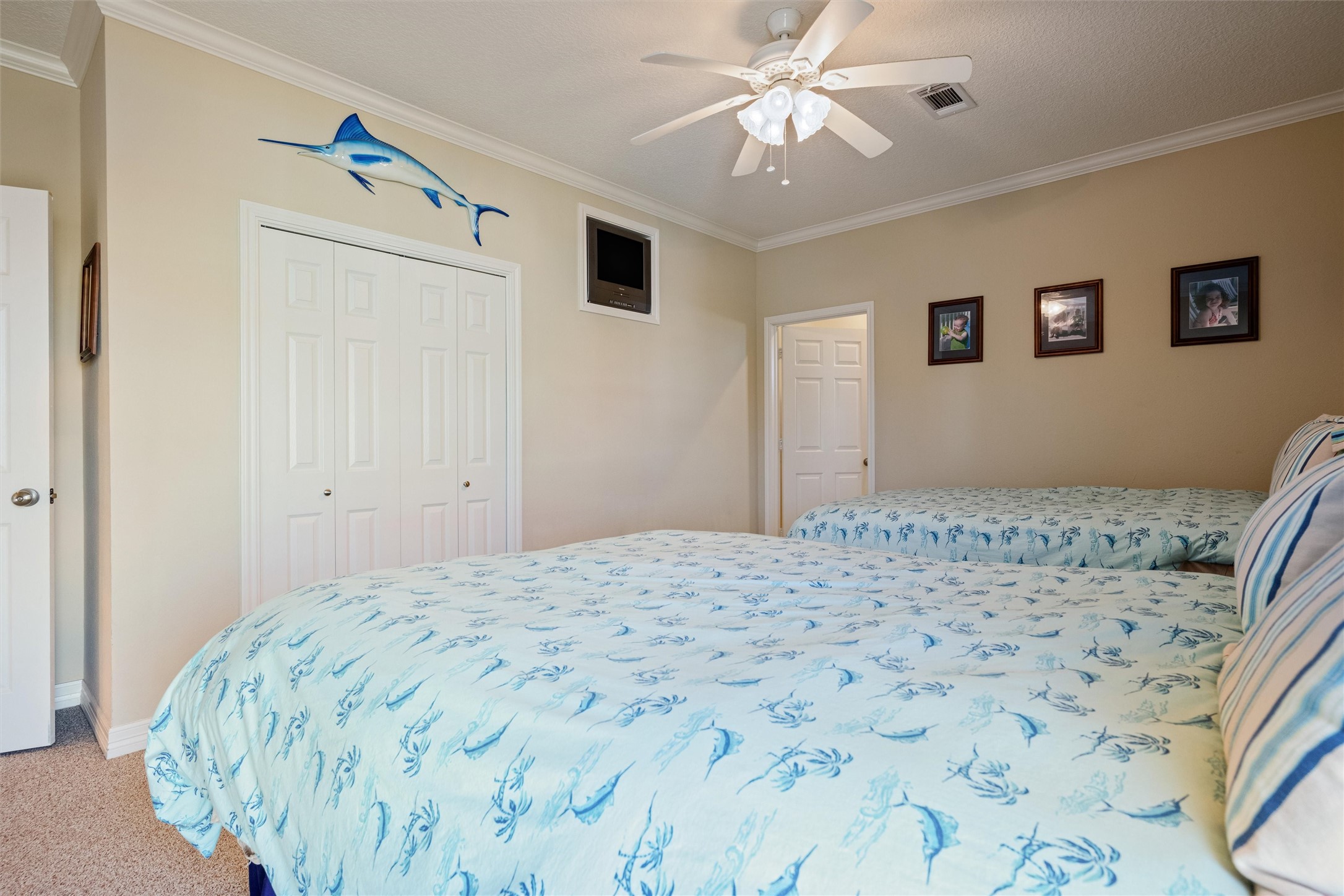 3125 James Street Crystal Beach, TX 77650 - Photo 36 of 45 a bedroom with a bed and a chandelier