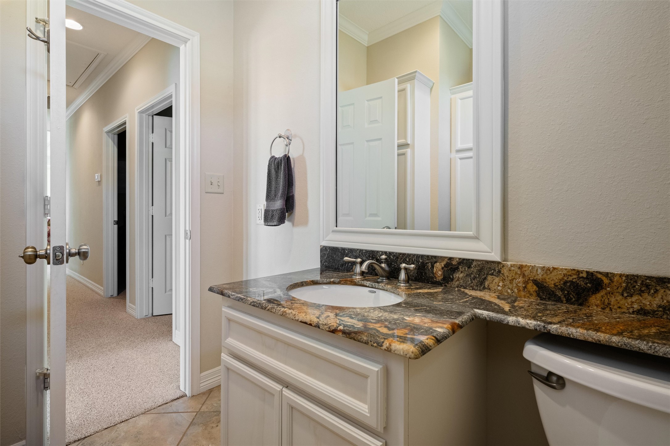 3125 James Street Crystal Beach, TX 77650 - Photo 38 of 45 a bathroom with a granite countertop sink and a mirror