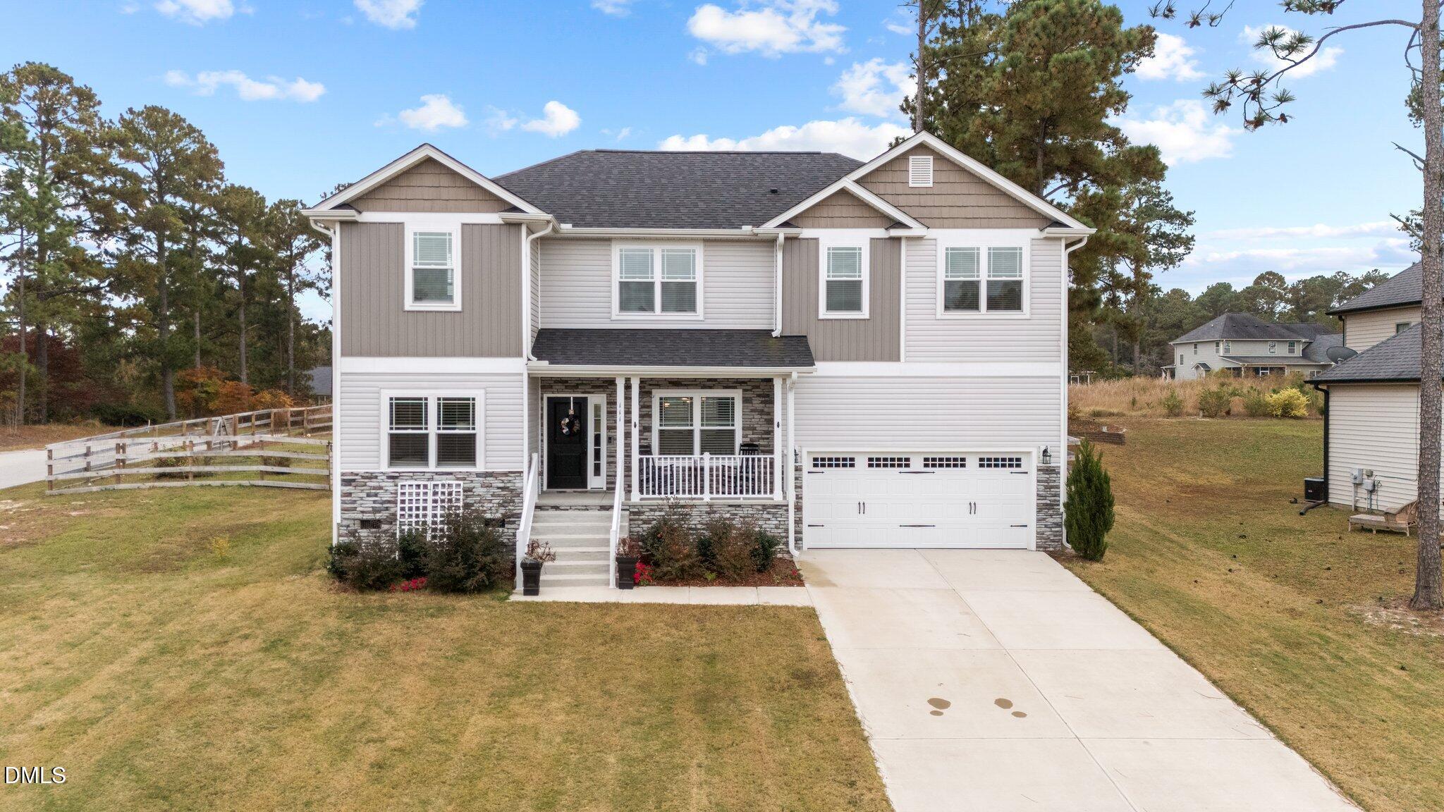 111 Spring Flowers Drive Cameron, NC 28326 - Photo 1 of 31 a front view of a house with a yard