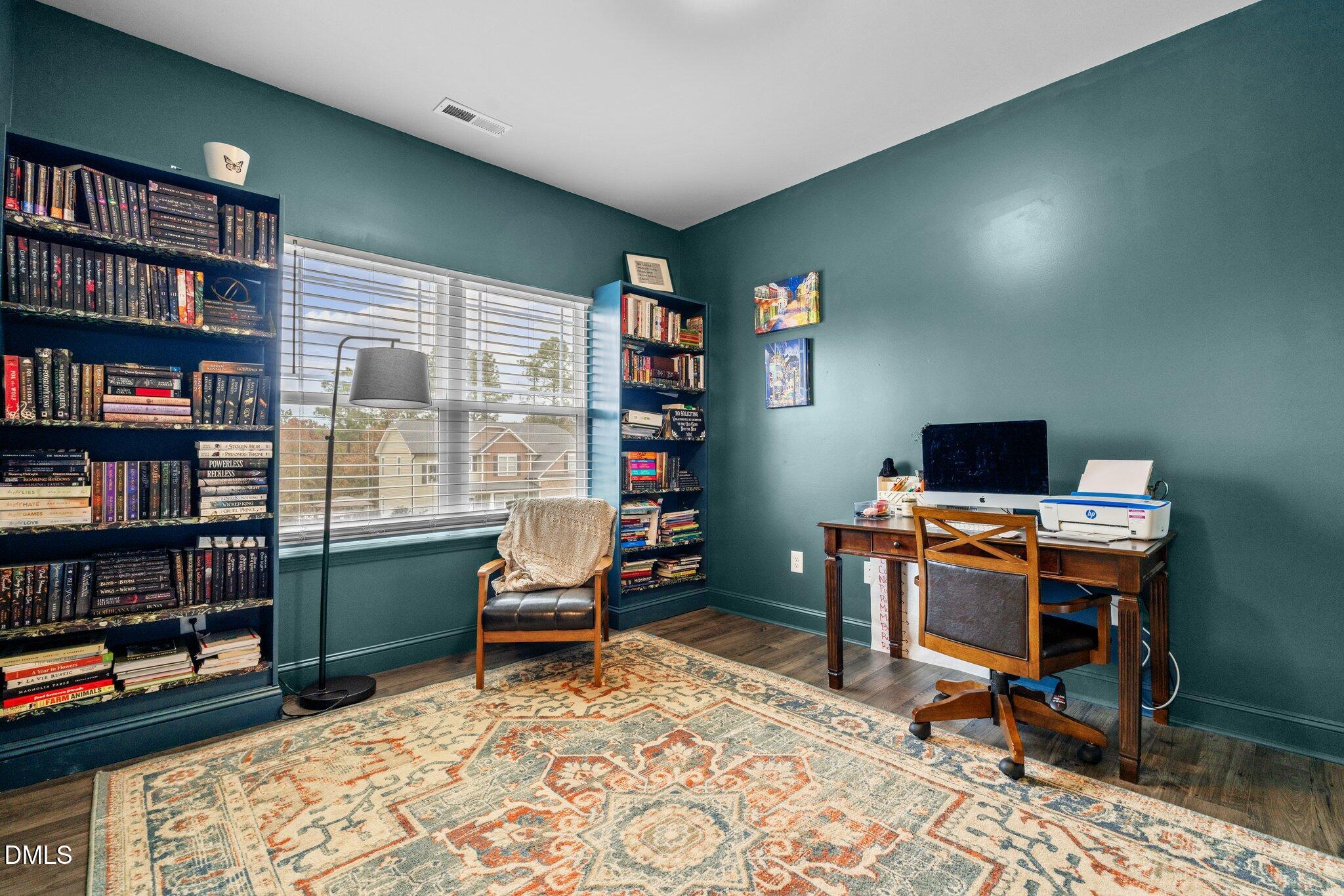 111 Spring Flowers Drive Cameron, NC 28326 - Photo 11 of 31 a view of a workspace with furniture and a bookshelf