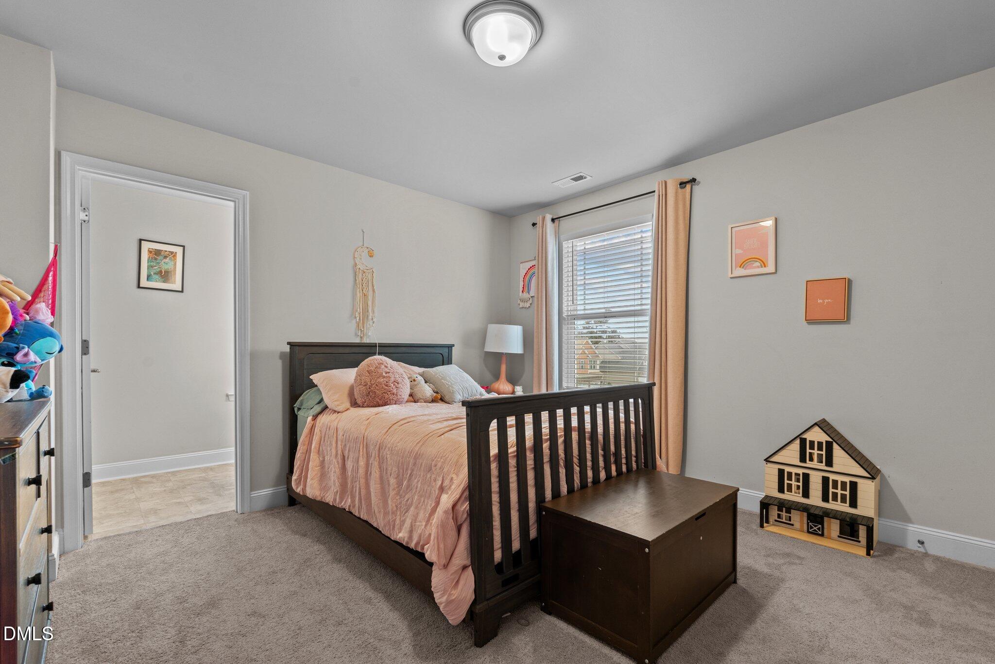 111 Spring Flowers Drive Cameron, NC 28326 - Photo 17 of 31 a bedroom with furniture and a window