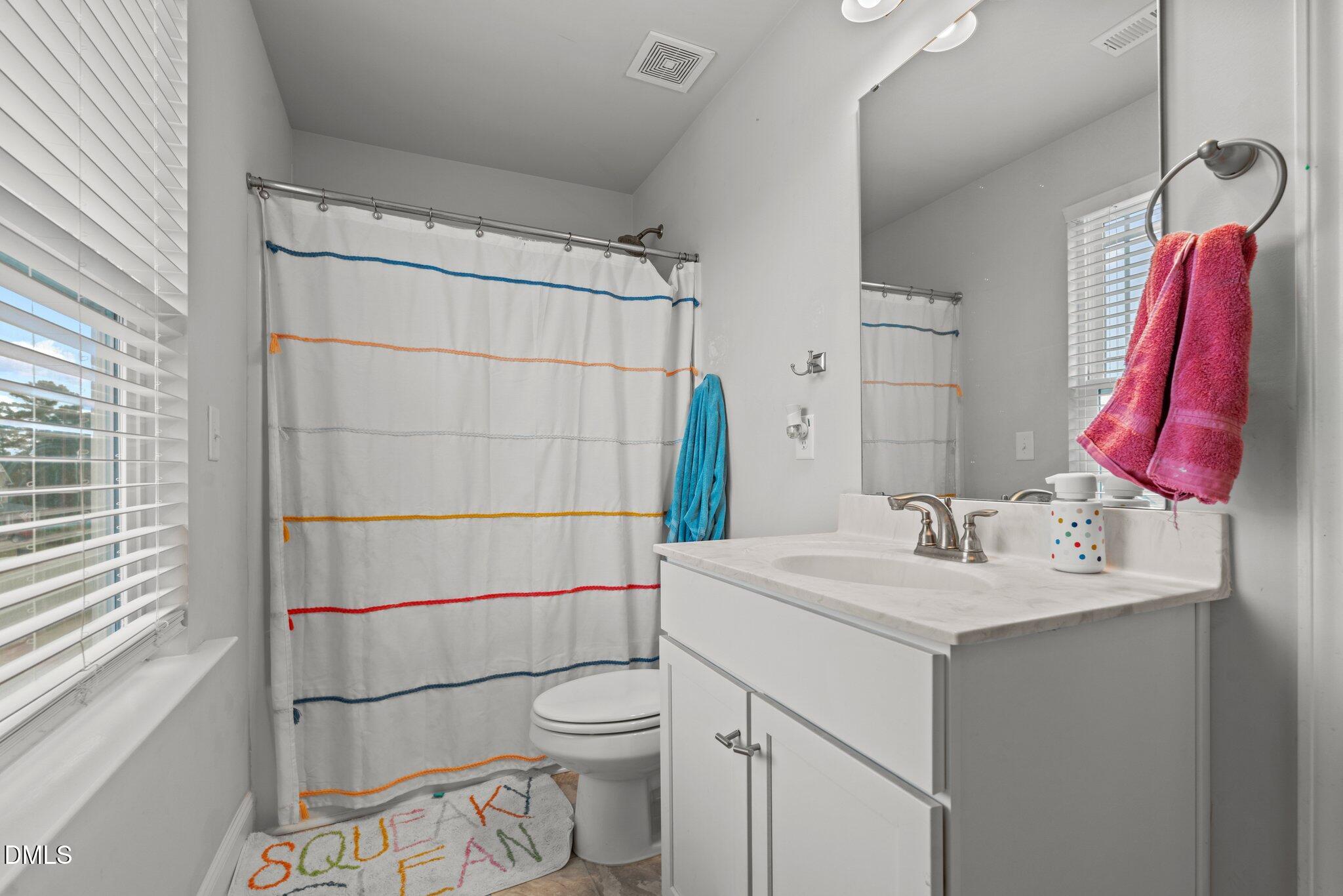 111 Spring Flowers Drive Cameron, NC 28326 - Photo 18 of 31 a bathroom with a sink vanity mirror and toilet