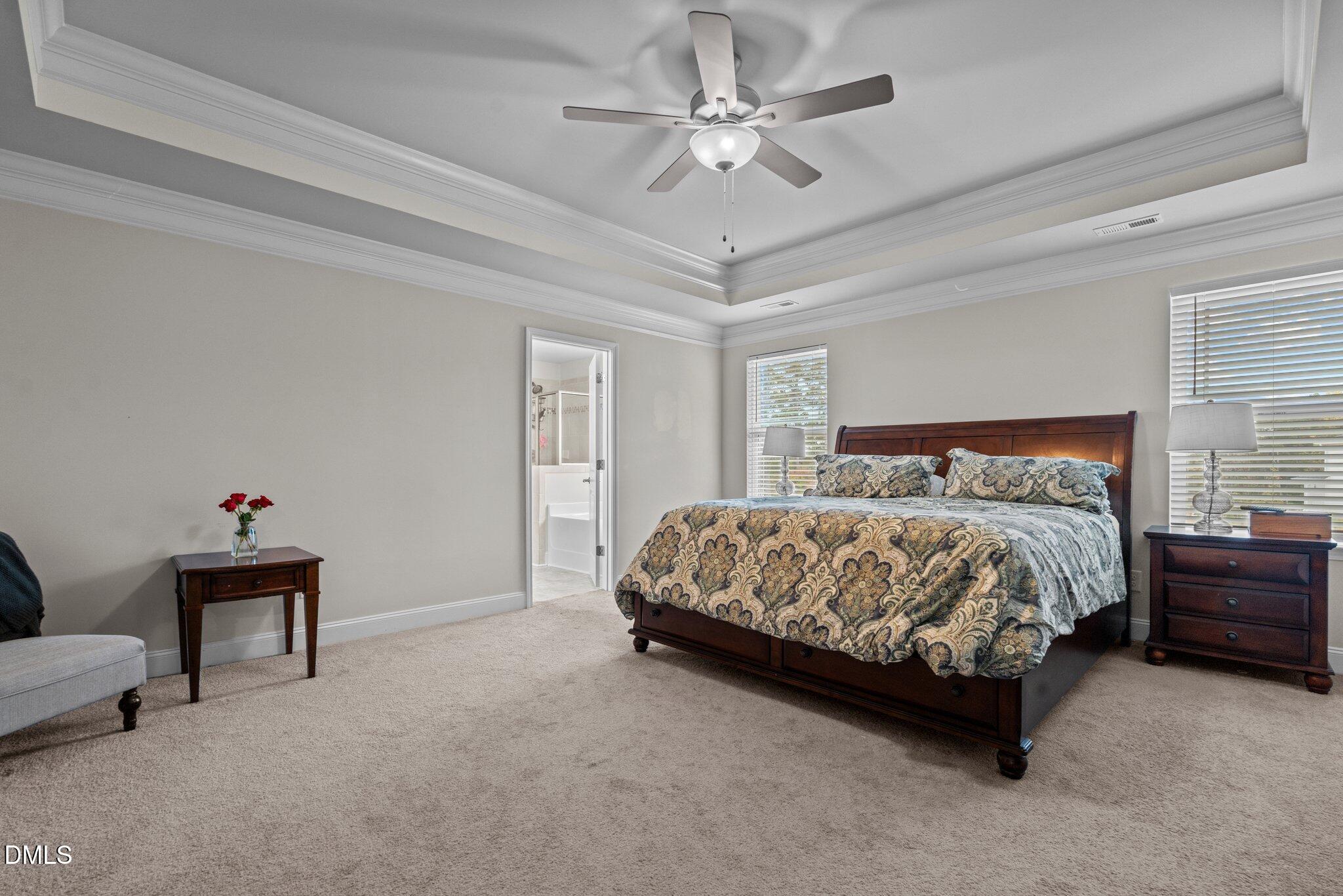 111 Spring Flowers Drive Cameron, NC 28326 - Photo 19 of 31 a bedroom with a bed and a chandelier