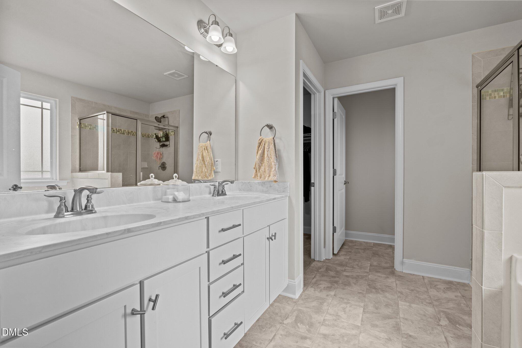 111 Spring Flowers Drive Cameron, NC 28326 - Photo 21 of 31 a spacious bathroom with a double vanity sink mirror and double