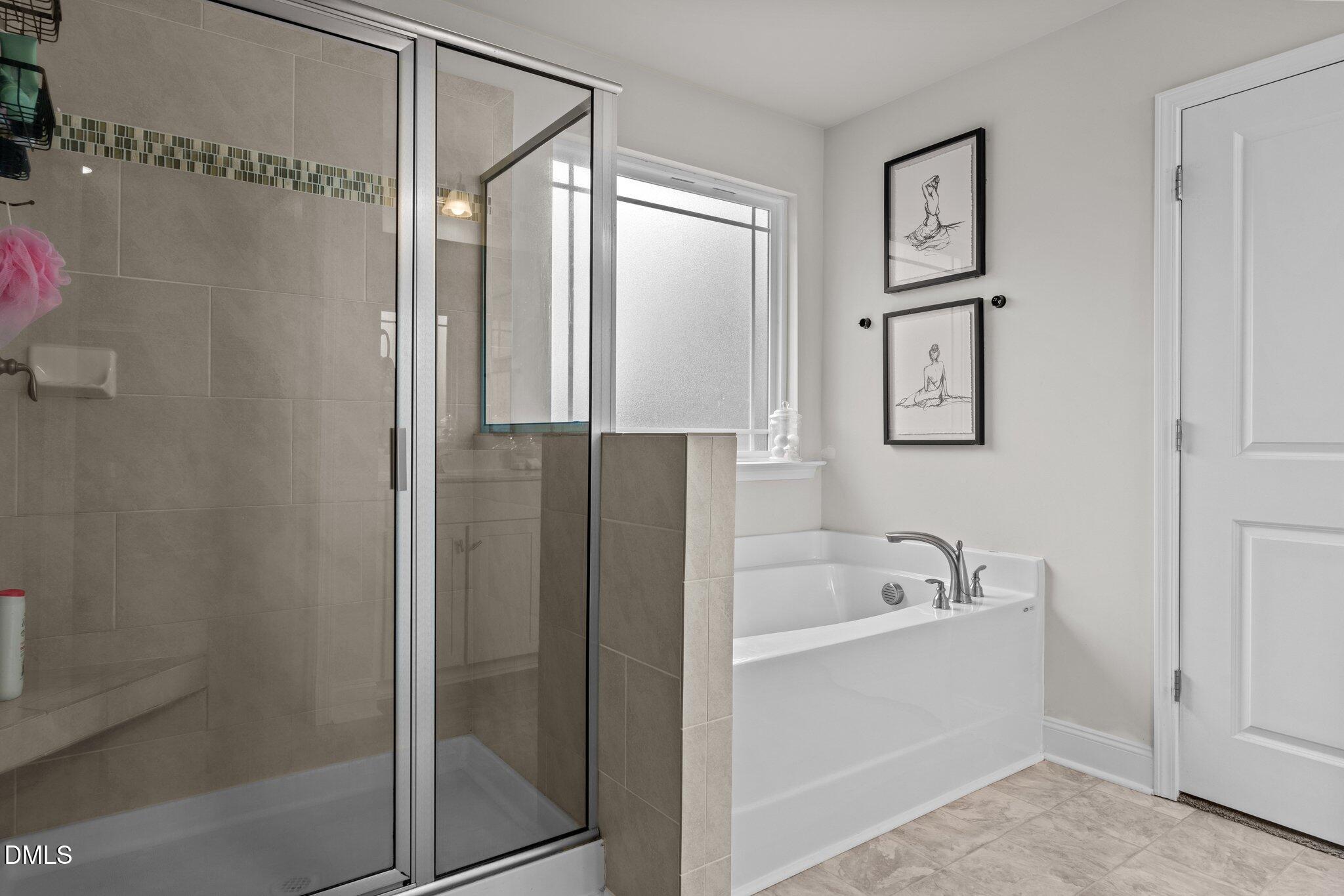 111 Spring Flowers Drive Cameron, NC 28326 - Photo 22 of 31 a bathroom with a bathtub and a shower