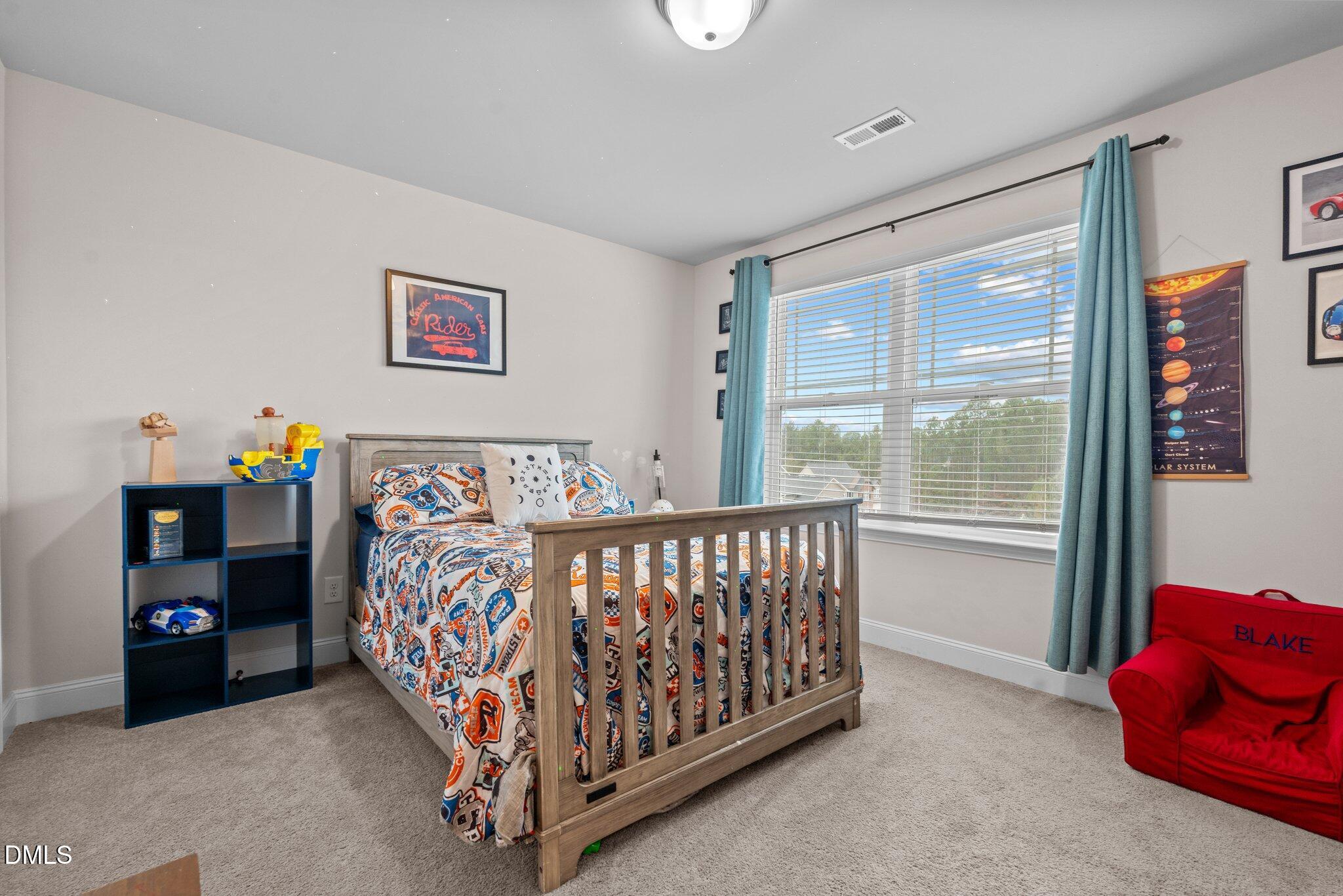 111 Spring Flowers Drive Cameron, NC 28326 - Photo 24 of 31 a bedroom with a bed and a window