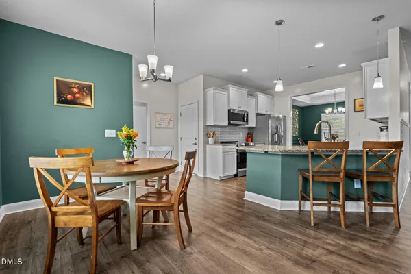 a view of a dining room with furniture and wooden floor