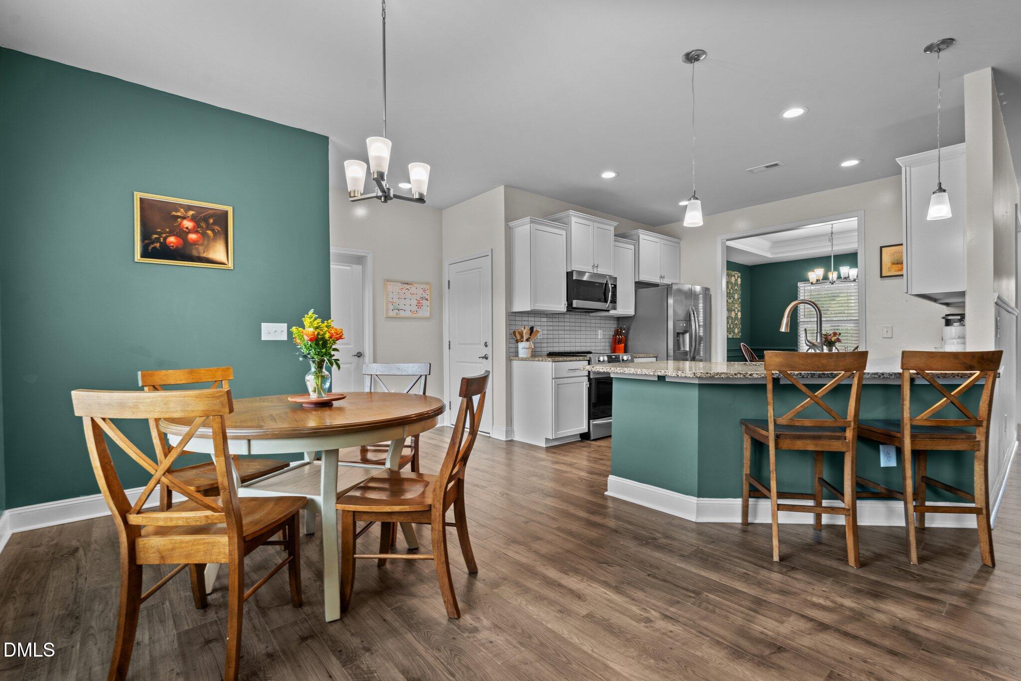111 Spring Flowers Drive Cameron, NC 28326 - Photo 4 of 31 a view of a dining room with furniture and wooden floor