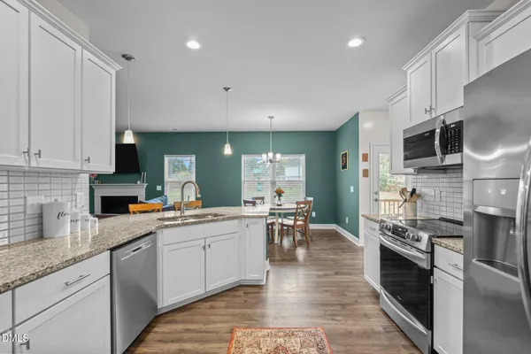 a kitchen with stainless steel appliances a stove sink microwave and cabinets