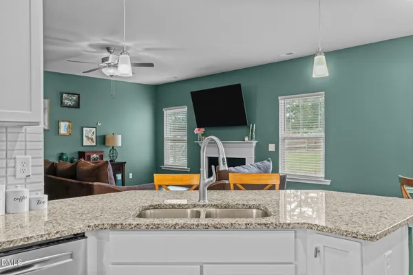 a kitchen with stainless steel appliances granite countertop a sink and a granite counter tops