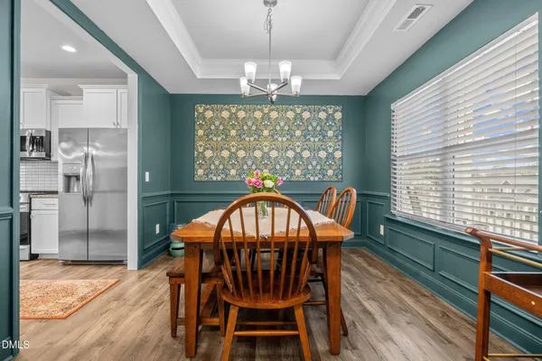 a view of a dining room with furniture window and wooden floor