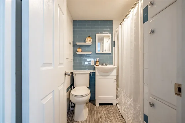 a white toilet sitting next to a bathroom sink