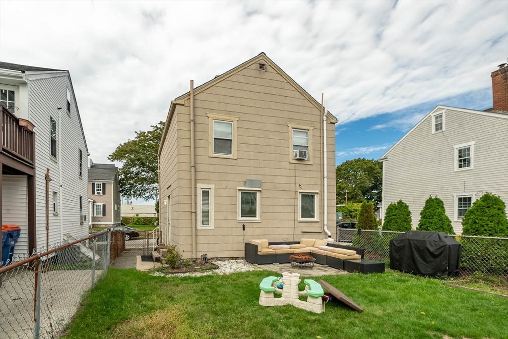 17 Middle Street Fairhaven, MA 02719 - Photo 15 of 18 a front view of house with yard and outdoor seating